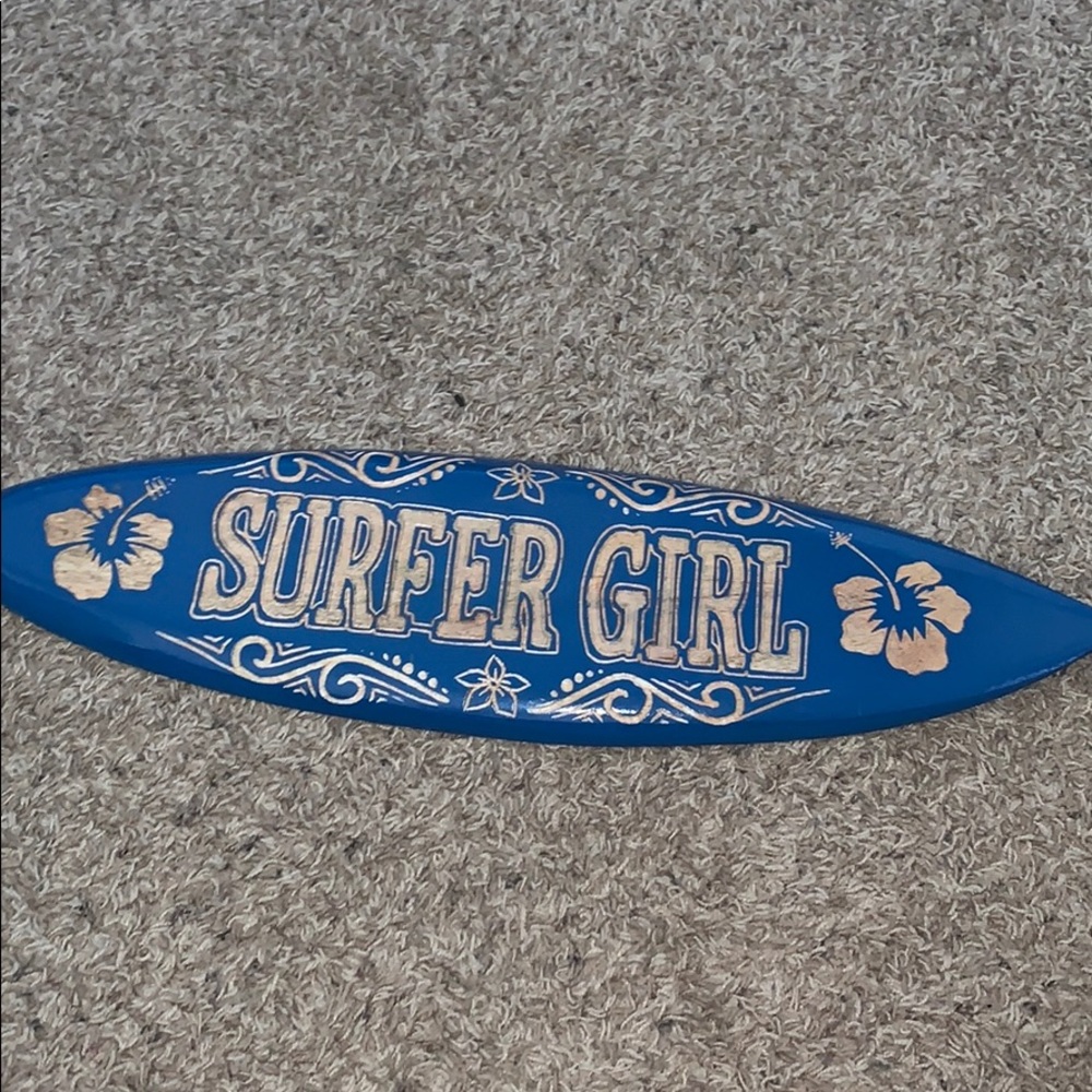 blue tiny surf board with surfer girl on it